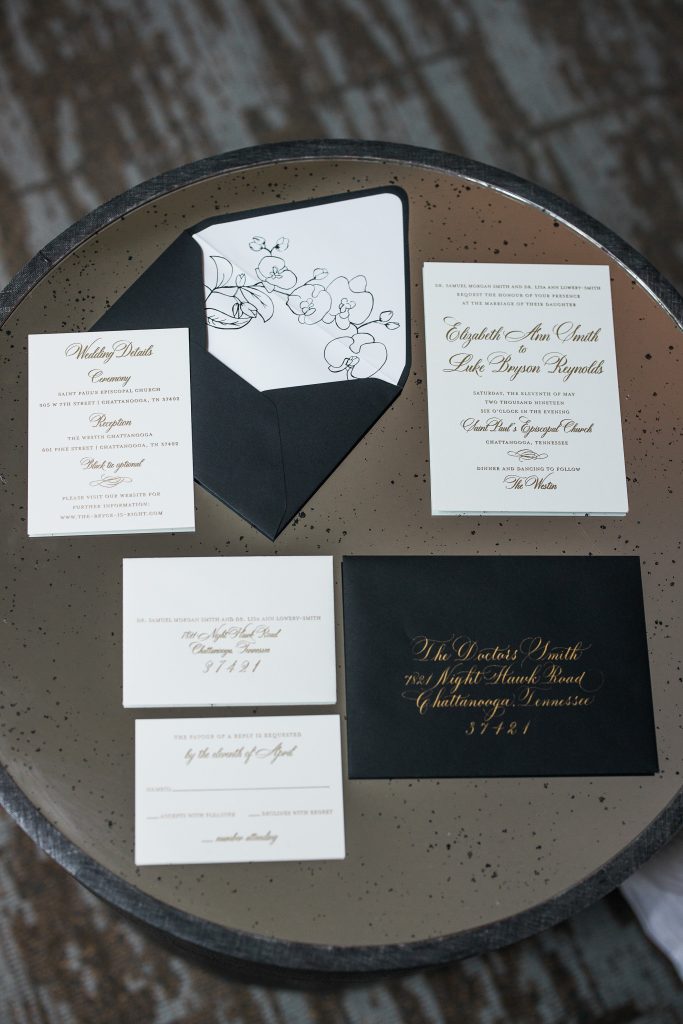 black and white wedding invites on a table