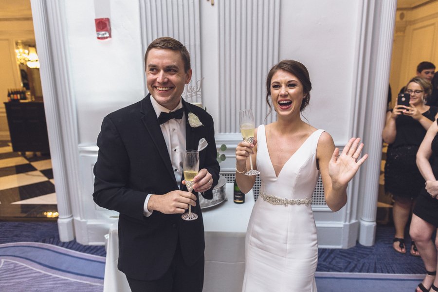 An authentic photo showing a bride and grooms reaction during a toast. 